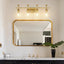Lámpara baño 4 luces 29" oro cepillado vidrio transparente