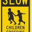 Letrero aluminio Slow Children Crossing 18x12" negro