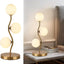 Lámpara mesa globo dorado 3 luces pantalla vidrio blanco