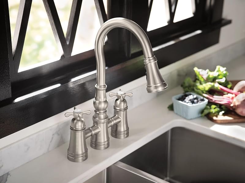 Grifo cocina acero inox puente abatible dos manijas