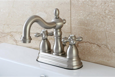 Grifo lavabo central 4pulg mango cruzado níquel