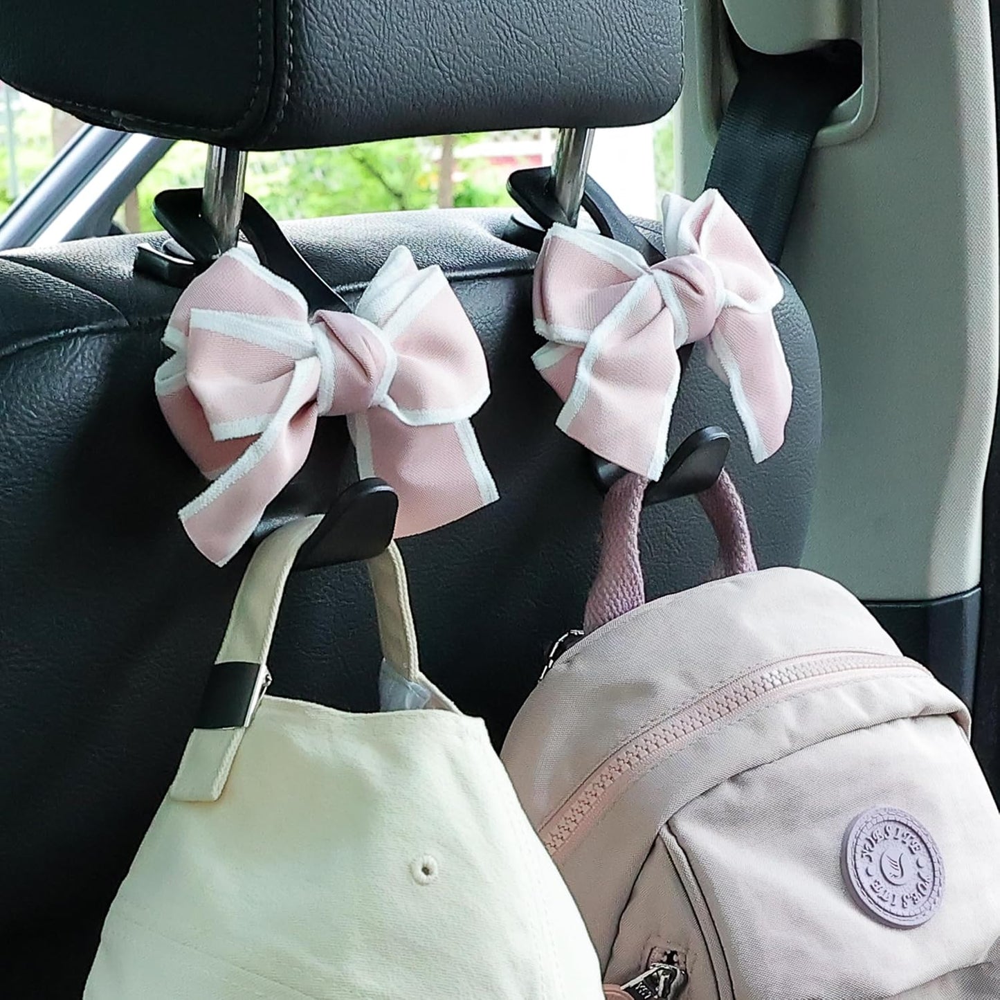 Gancho reposacabezas coche con moño organiz. negro y rosa