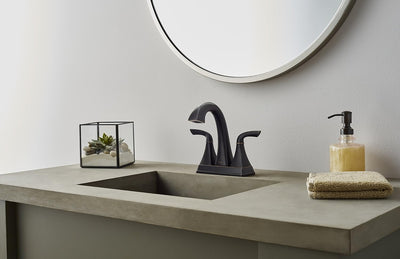 Grifo baño central 2 manijas 4pulg bronce toscano